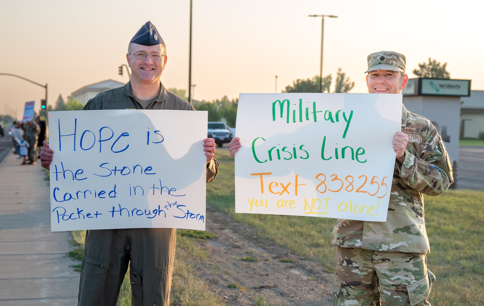 Two U.S. Air Force Officers hold positive signs