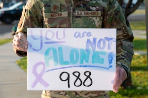 Airman holds positive sign