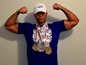 U.S. Air Force Master Sgt. Ryan Hines, a Purple Heart recipient and Air Force Wounded Warrior Ambassador and Mentor from Tampa, Florida, assigned to the 6th Logistics Readiness Squadron at MacDill Air Force Base, Florida, displays his collection of Department of Defense Warrior Games medals won during the 2024 and 2025 Warrior Games trials and a gold medal during his first-time participation for Team Air Force in indoor rowing July 21, 2025, in Colorado Springs, Colorado. The 2025 Warrior Games, held July 18-26 under the “Limitless” theme, united nearly 200 wounded, ill and injured service members and veterans from all U.S. military branches, competing for 800 medals across 11 adaptive sports. (Courtesy photo by Master Sgt. Ryan Hines)