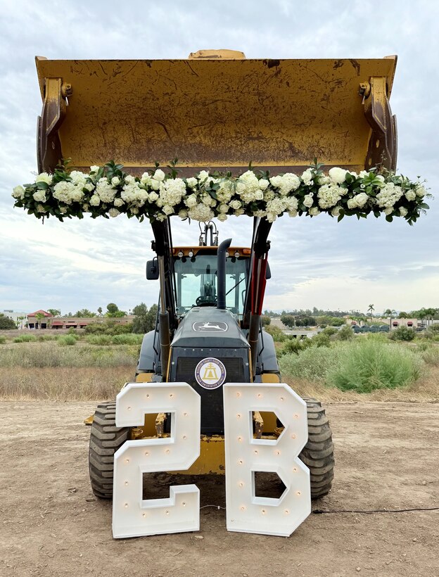 A backhoe loader decorated with flowers and a “2B” display is staged for the Aug. 28 groundbreaking ceremony for Phase 2B of the Murrieta Creek Flood Control, Environmental Restoration and Recreation Project in Temecula, California.