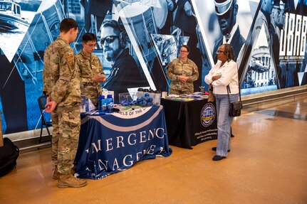 Airmen talk with a community member about National Preparedness Month at Joint Base Anacostia-Bolling, Washington, D.C., Sept. 9, 2025.