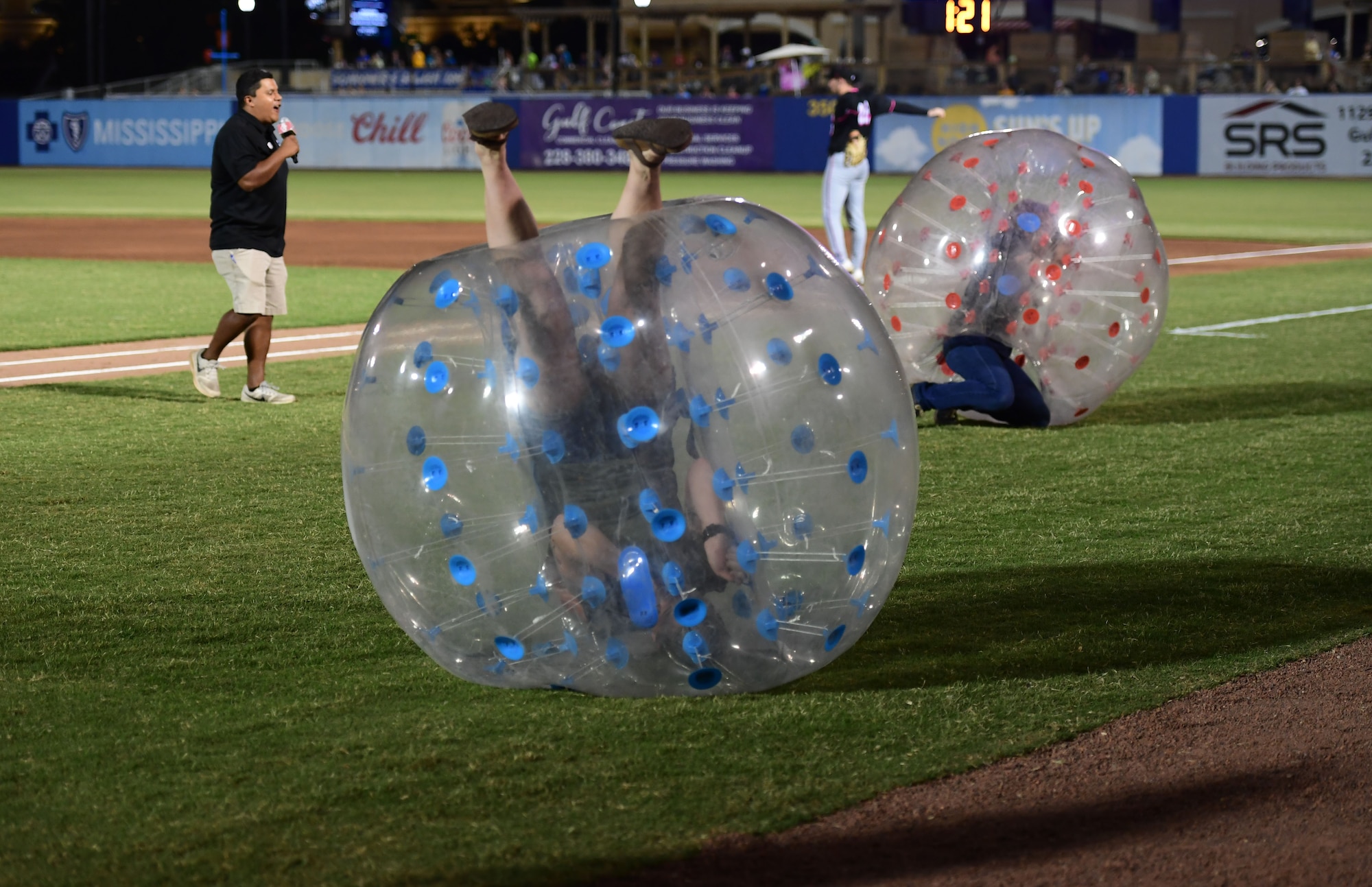 Two people are inside large plastic balls.