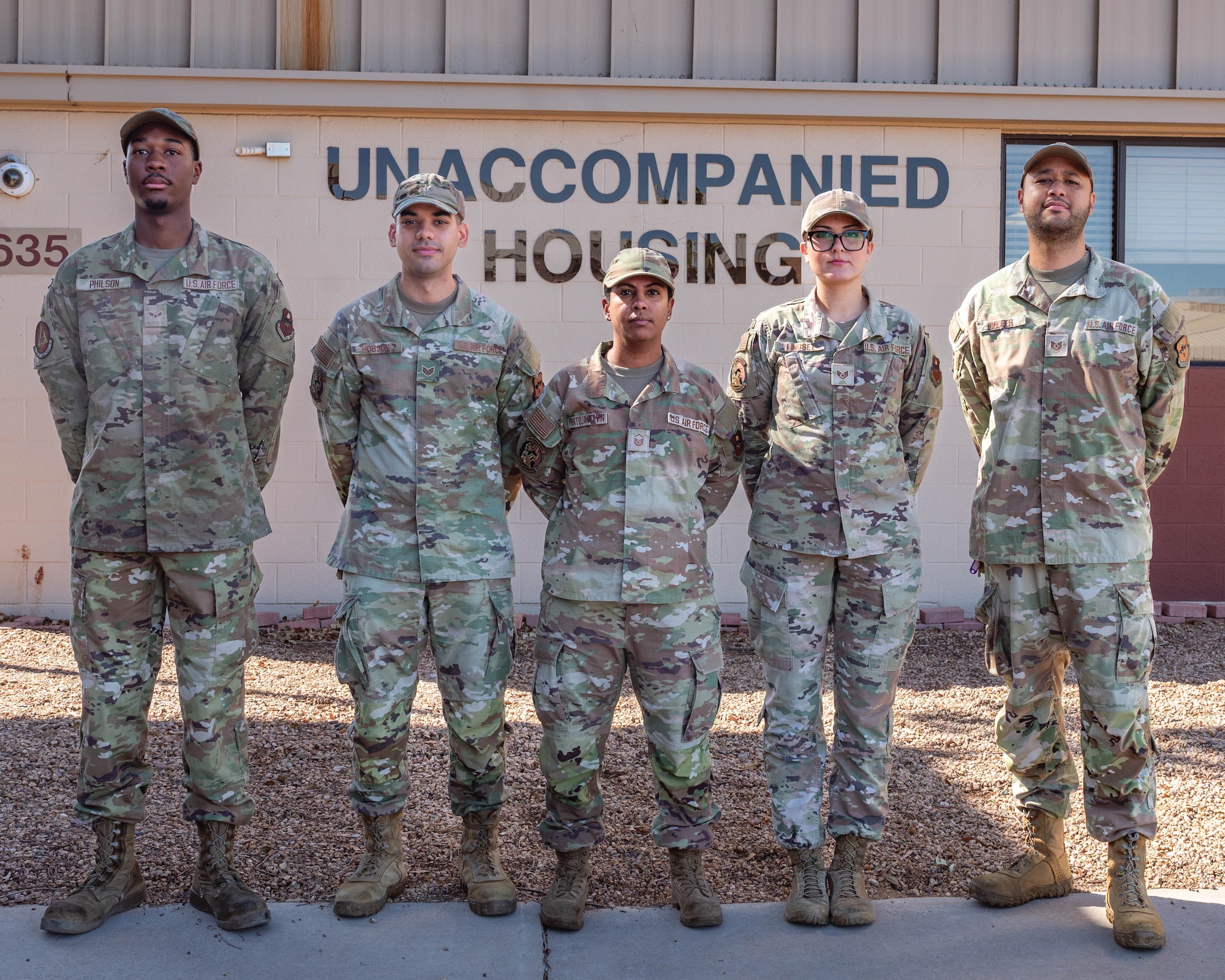 U.S. Air Force 56th Civil Engineer Squadron Dorm Management Team, stand in front of the unaccompanied housing building, Sept. 8, 2025, at Luke Air Force Base, Arizona.
