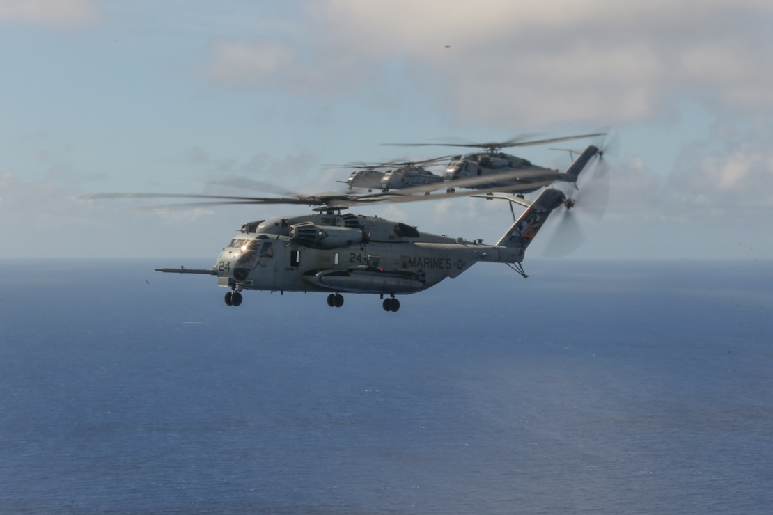 U.S. Marine CH-53E Super Stallion helicopters, assigned to Marine Heavy Helicopter Squadron 462, Marine Aircraft Group 36, 1st Marine Aircraft Wing, fly in formation off the coast of Okinawa, Japan, Sept. 8, 2025.