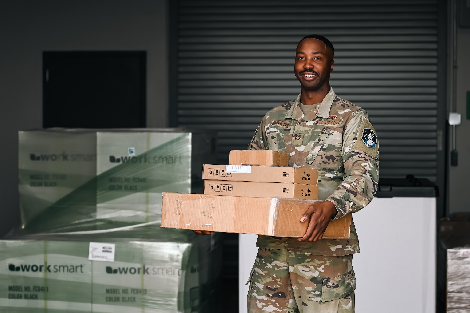 man hold boxes and poses for photo