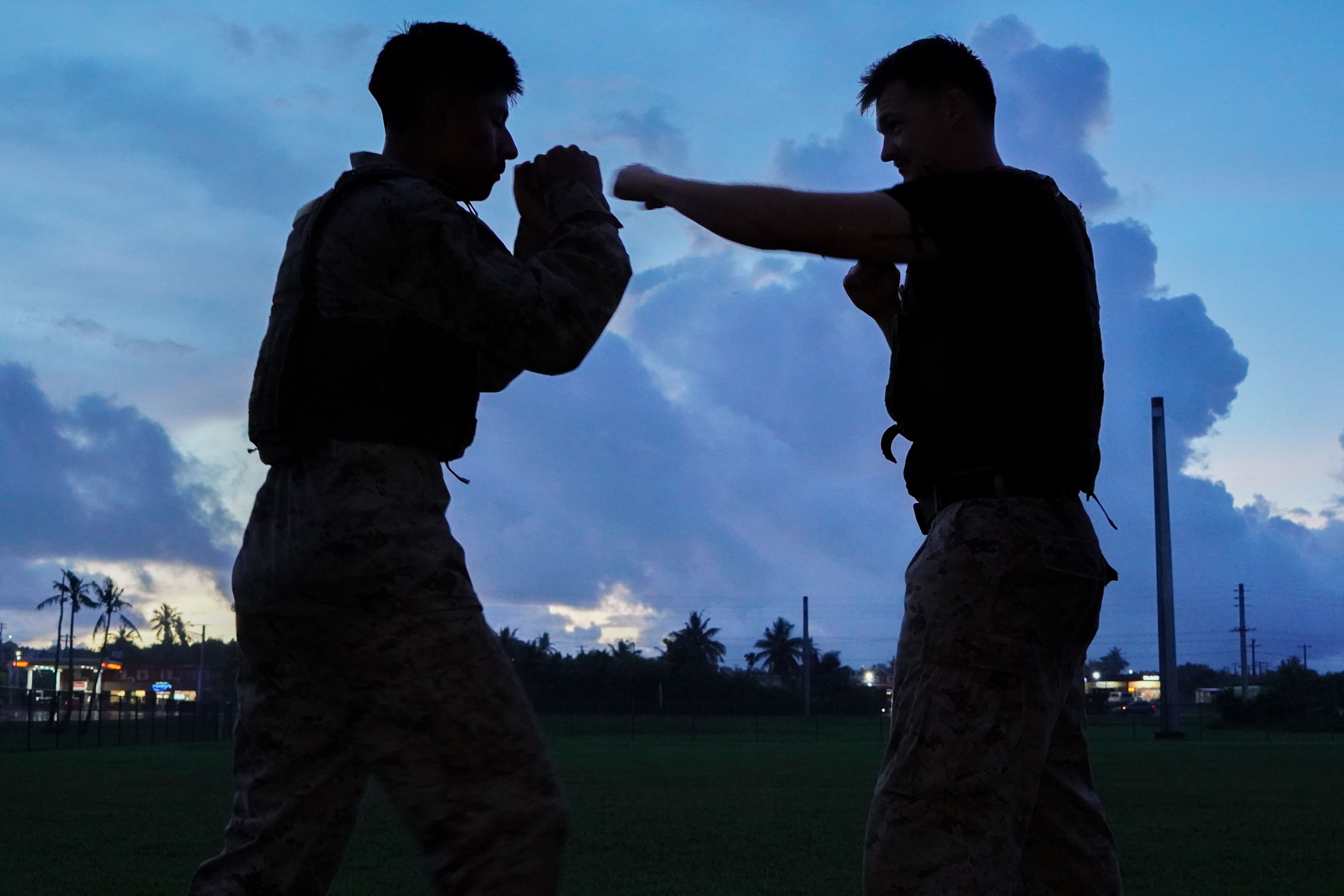 U.S. Marine Corps Sgt. Bennett Waters, armory chief, Headquarters Company, Marine Corps Base Camp Blaz, throws a lead hand punch to Pfc. Gabriel Cajas, military police, Provost Marshal’s Office, MCB Camp Blaz during a Marine Corps Martial Arts Program grey belt performance test, on MCB Camp Blaz, Guam, Aug. 28, 2025. MCMAP teaches Marines useful combat skills and implements a warfighting mindset. (U.S. Marine Corps photo by Lance Cpl. Afton Smiley