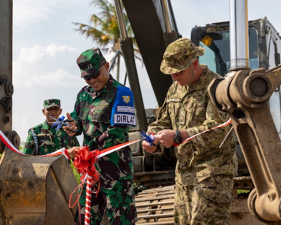 Indonesian Armed Forces Lt. Gen. Naudi Nurdika, commander of the Indonesian Army Education and Training Command, left, and Canadian Brig. Gen. Robert McBride, deputy commanding general, operations, 11th Airborne Division, right, cut ribbons opening a newly constructed road during exercise Super Garuda Shield 25 in Baturaja, Indonesia, Sept. 2, 2025.
