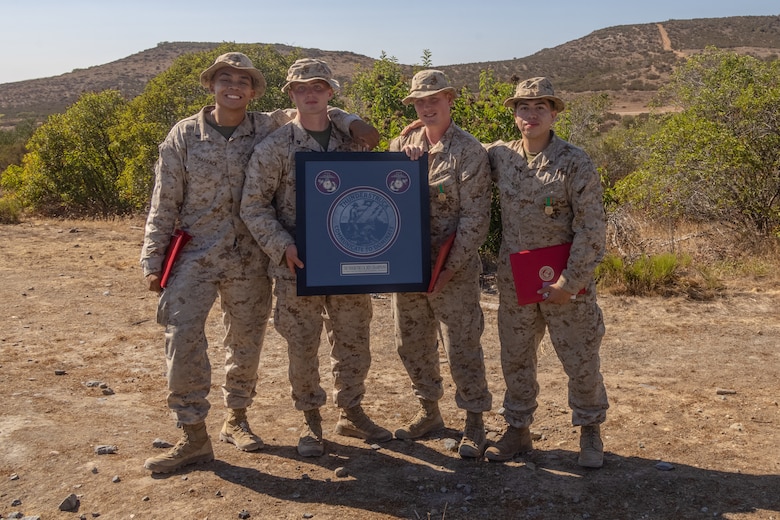 U.S. Marines from Communications Company, 1st Marine Logistics Group, I Marine Expeditionary Force, pose for a photograph after receiving an award and Navy and Marine Corps Achievement Medals for winning first place in the inaugural Thunderstruck Communications Competition