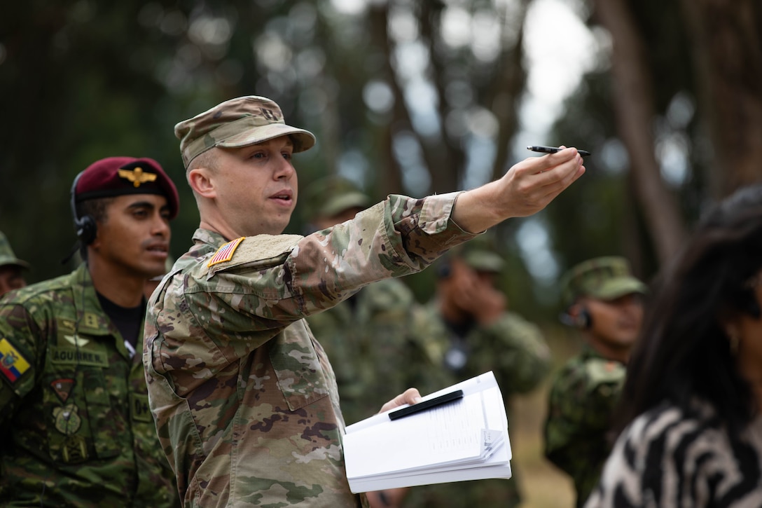 U.S. Army Capt. Mitchell Hagen teaches Ecuadorian servicemembers of the 9th Special Forces Brigade how to approximate the height of trees as part of a class on landing zone designation in Latacunga, Ecuador, Aug. 21, 2025.