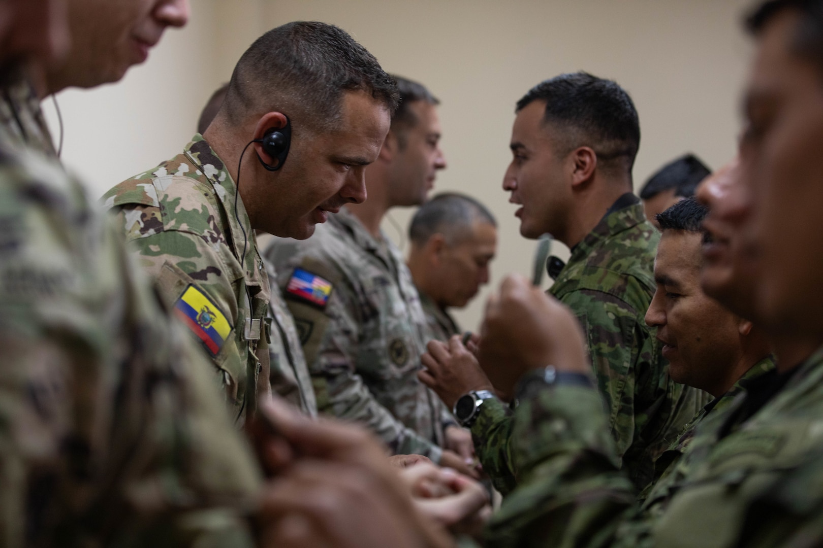 Soldiers and Airmen of the Kentucky National Guard exchange patches with members of the Ecuadorian 9th Special Forces Brigade at the conclusion of an air assault exchange in Latacunga, Ecuador, Aug. 21, 2025.