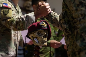 U.S. Army Maj. Ryan Hubbs congratulates an Ecuadorian marine on the completion of air assault training during a ceremony at the end of an air assault training exchange in Latacunga, Ecuador, Aug. 21, 2025.