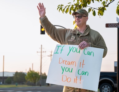 U.S. Air Force Colonel hold positive sign and waves