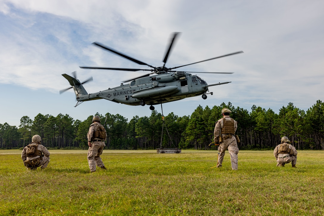 A U.S. Marine Corps CH-53E Super Stallion assigned to Marine Heavy Helicopter Training Squadron (HMMT) 302, Marine Aircraft Group 29, 2nd Marine Aircraft Wing, lifts an I-beam during helicopter support team operations near Marine Corps Base Camp Lejeune, North Carolina, Sept. 8, 2025. 2nd Distribution Support Battalion, Combat Logistics Regiment 2, 2nd Marine Logistics Group, conducted HST training to prepare HMMT 302, Marines to manage landing zone operations and efficiently handle the pickup, movement, and landing of helicopter-borne troops, equipment, and heavy loads in combat scenarios. (U.S. Marine Corps photo by Sgt. Rafael Brambila-Pelayo)
