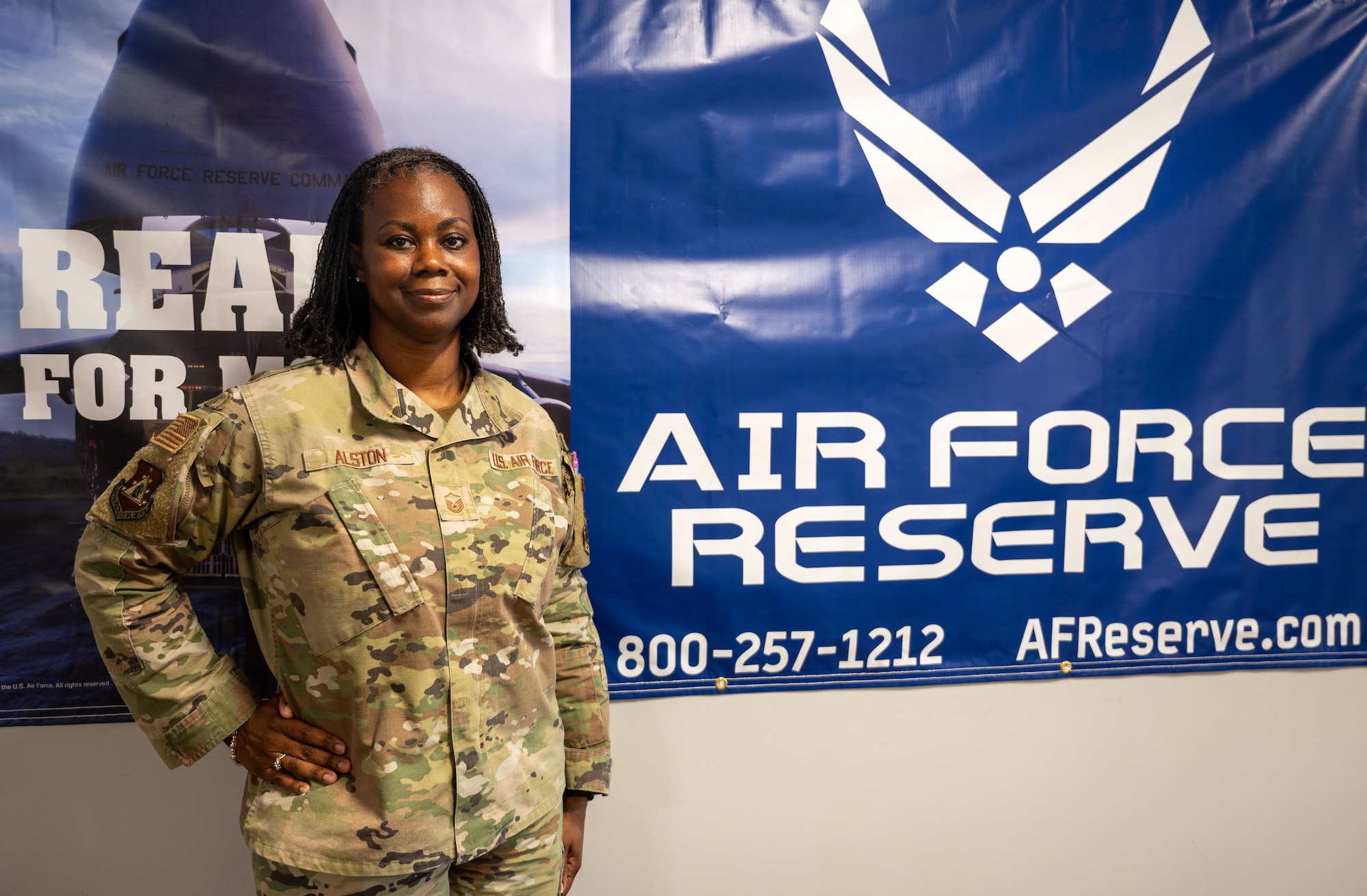 Master Sgt. Denise Alston, recruiting flight chief for the 315th Airlift Wing, stands beside a Reserve marketing display outside her office at Joint Base Charleston, South Carolina, Aug. 2, 2025. Recruiters play a critical role in preparing future Airmen for military service.