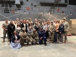 The USMEPCOM military member and civilian employee of the year finalists pose for a photo during the Naval Station Great Lakes battle station.