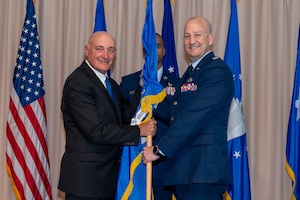 Image of two people holding a flag.