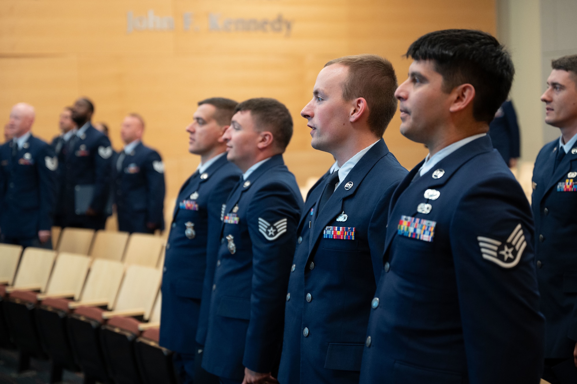 Airmen stand at attention.
