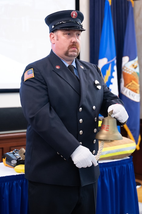 image of firefighter tolling bell