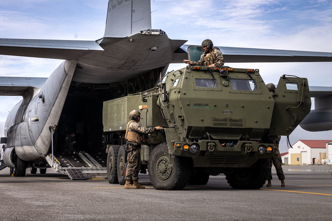 U.S. Marines with 2nd Battalion, 14th Marine regiment, 4th Marine Division, unloads a High Mobility Artillery Rocket System (HIMARS) during ARTIC EDGE 25  in Cold Bay, Alaska, Aug. 17th, 2025. AE25 is a NORAD and U.S. Northern Command-led homeland defense exercise designed to improve readiness, demonstrate capabilities and enhance Joint and Allied Force interoperability in the Arctic. (U.S. Marine Corps Photo by Lance Cpl. Edward Spears)