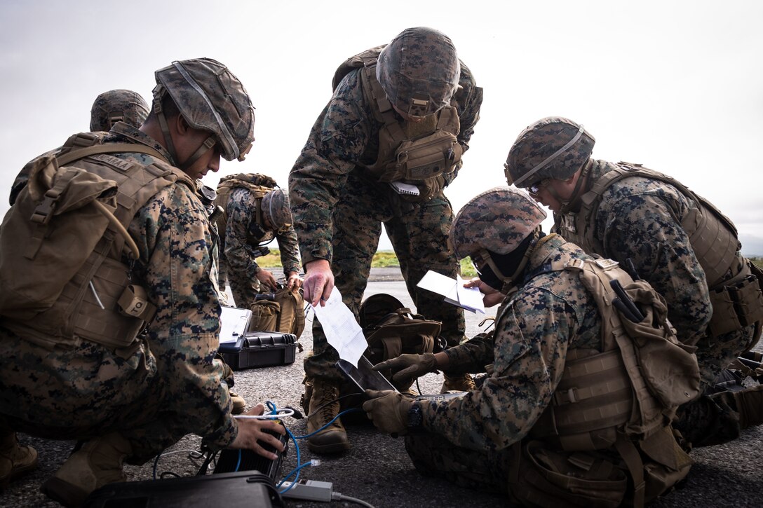 U.S. Marines with 2nd Battalion, 14th Marine regiment, 4th Marine Division, sets up telecommunication devices during High Mobility Artillery Rocket System (HIMARS) Dry-Fire training as part of ARTIC EDGE 25 at Cold Bay, Alaska, Aug. 17th, 2025. AE25 is a NORAD and U.S. Northern Command-led homeland defense exercise designed to improve readiness, demonstrate capabilities and enhance Joint and Allied Force interoperability in the Arctic. (U.S. Marine Corps Photo by Lance Cpl. Edward Spears)