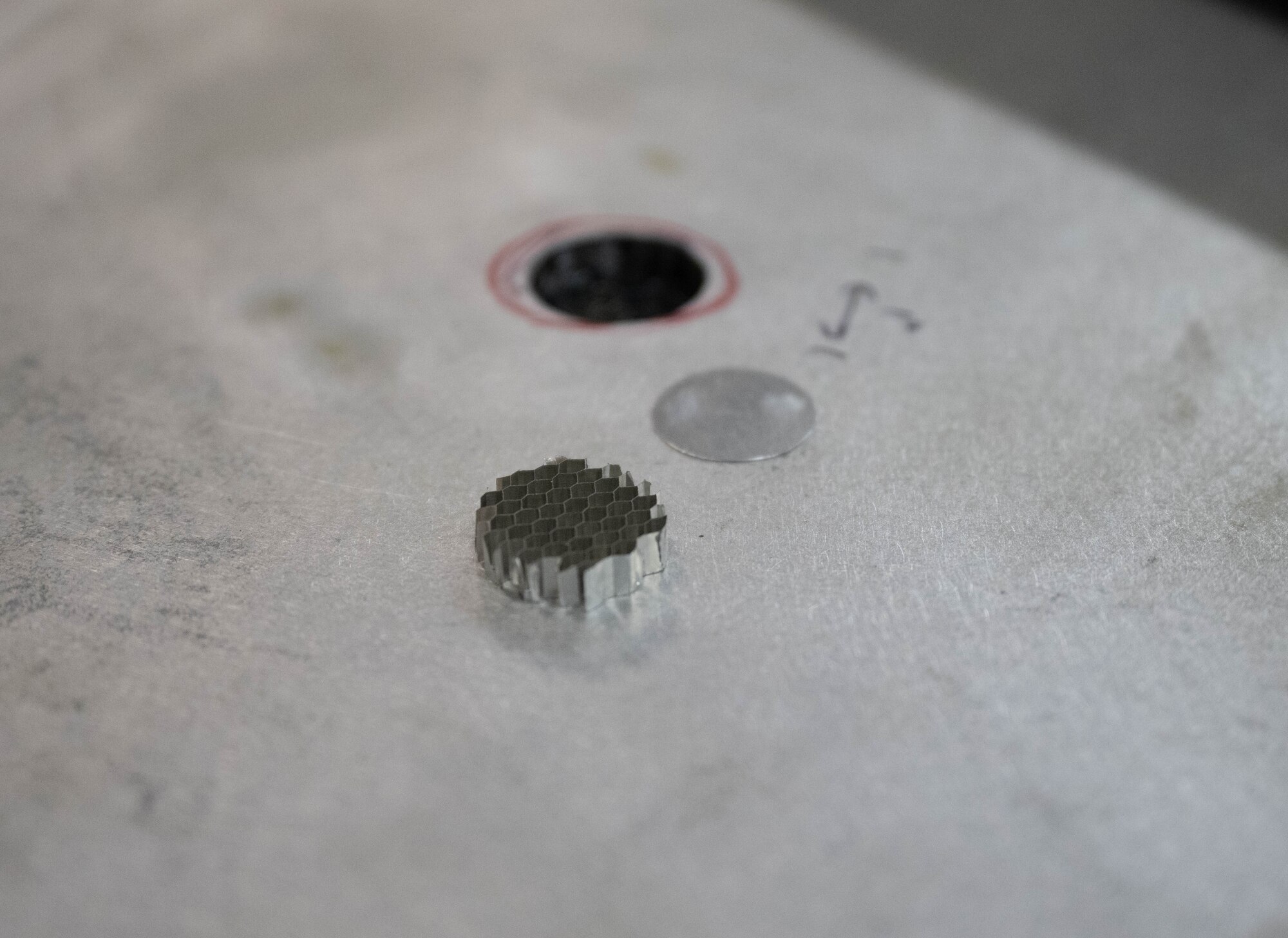 A piece of metal sitting atop an aircraft component with specific measurements written down at Laughlin Air Force Base, Texas, Sept. 10, 2025.  This was performed by the 47th Maintenance Directorate, who’s primary objective is to furnish quality aircrafts for the base. (U.S. Air Force photo by Airman 1st Class Darryl Keith.)