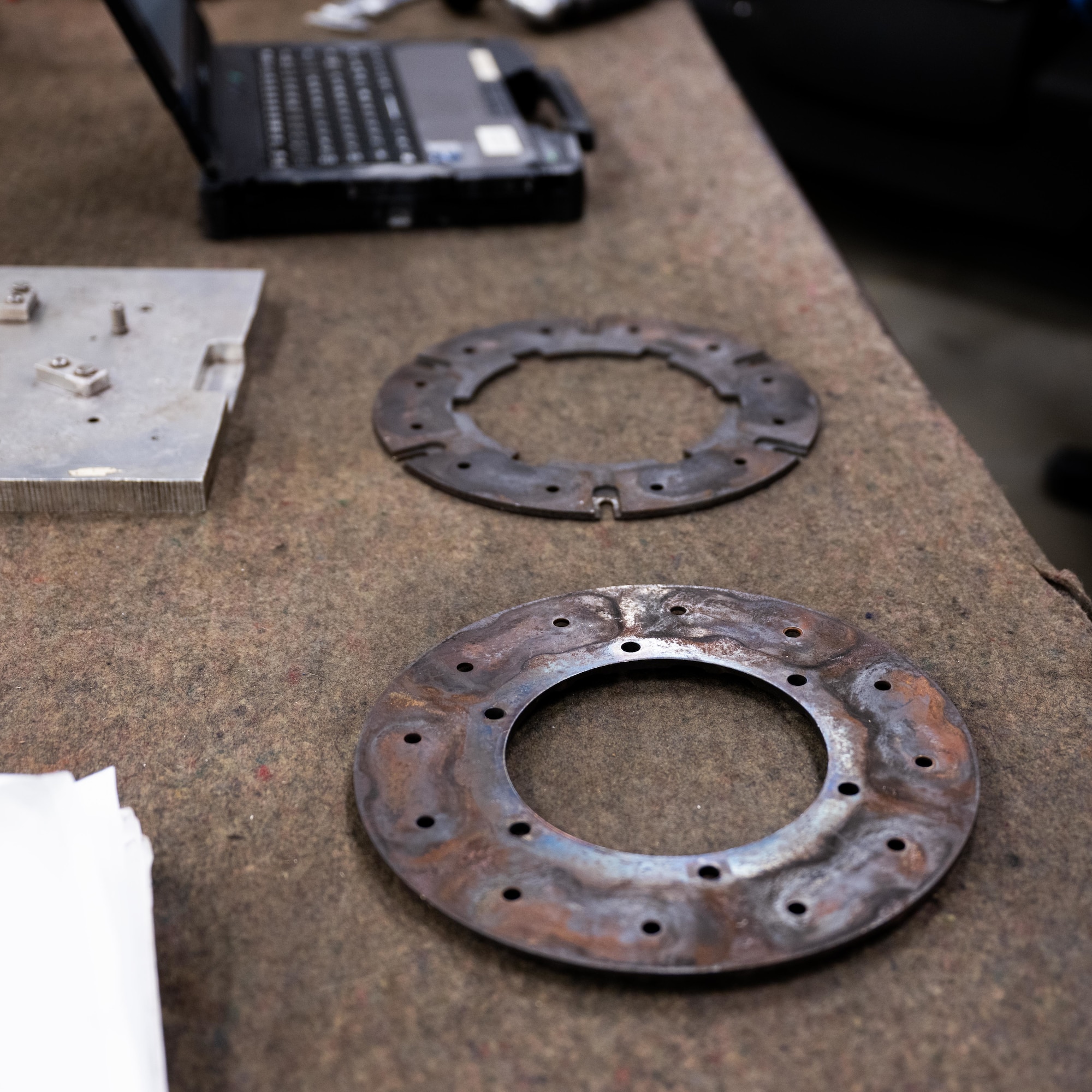 A set of aircraft component parts rest on a workbench at Laughlin Air Force Base, Texas, Sept. 10, 2025. The 47th Flying Training Wing Maintenance Directorate uses reverse engineering and additive manufacturing to reproduce obsolete components, ensuring continued operations for trainer aircraft like the T-6 Texan II. (U.S. Air Force photo by Airman 1st Class Harrison Sullivan)