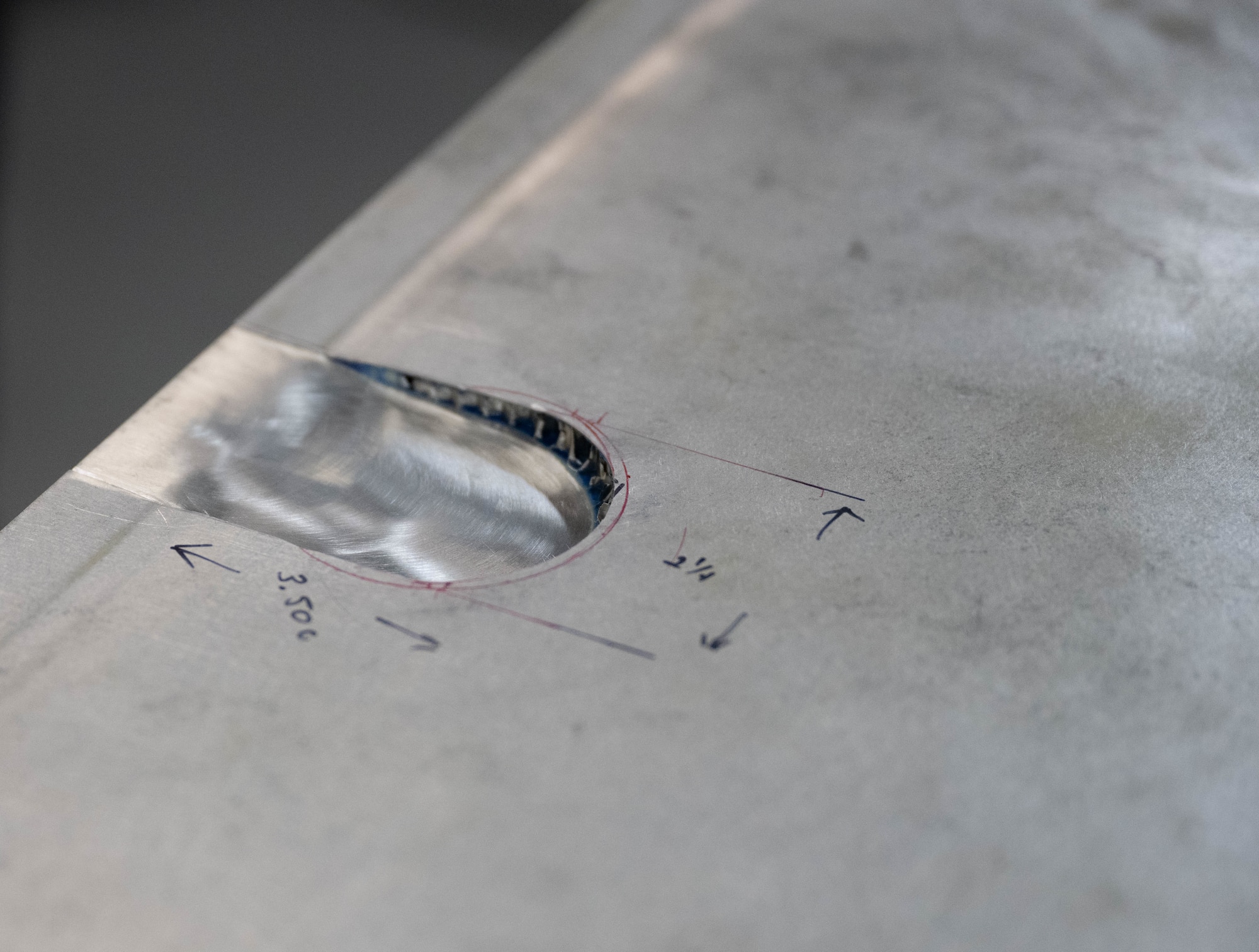A dented aircraft component with specific measurements written down at Laughlin Air Force Base, Texas, Sept. 10, 2025.  This was performed by the 47th Maintenance Directorate, who’s primary objective is to furnish quality aircrafts for the base. (U.S. Air Force photo by Airman 1st Class Darryl Keith.)