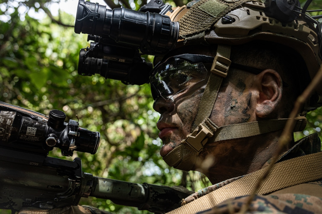 A U.S. Marine with Headquarters & Service Company, Battalion Landing Team 1st Battalion, 7th Marine Regiment, 31st Marine Expeditionary Unit, tests a 3D printed PVS-31 mount in a simulated field scenario at Camp Hansen, Okinawa, Japan, Aug. 28, 2025. Marines used a 3D printer to create an attachment that would turn a PVS-14 mount into a PVS-31 mount. The 31st MEU, the Marine Corps’ only continuously forward-deployed MEU, provides a flexible and lethal force ready to perform a wide range of military operations as the premiere crisis response force in the Indo-Pacific region. (U.S. Marine Corps photo by Lance Cpl. Raul Sotovilla)
