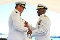 NAVAL STATION ROTA, Spain (Sep. 10, 2025) Capt. Alexander Mamikonian, former Commander, Task Force 65, Commodore of Destroyer Squadron (DESRON) 60, exchanges "El Bastón de Mando" to Capt. Kelechi R. Ndukwe Commander, Task Force 65, Commodore of DESRON 60, during the Command Task Force (CTF) 65, DESRON 60 change of command ceremony onboard Naval Station (NAVSTA) Rota, Spain, Sep. 10, 2025.