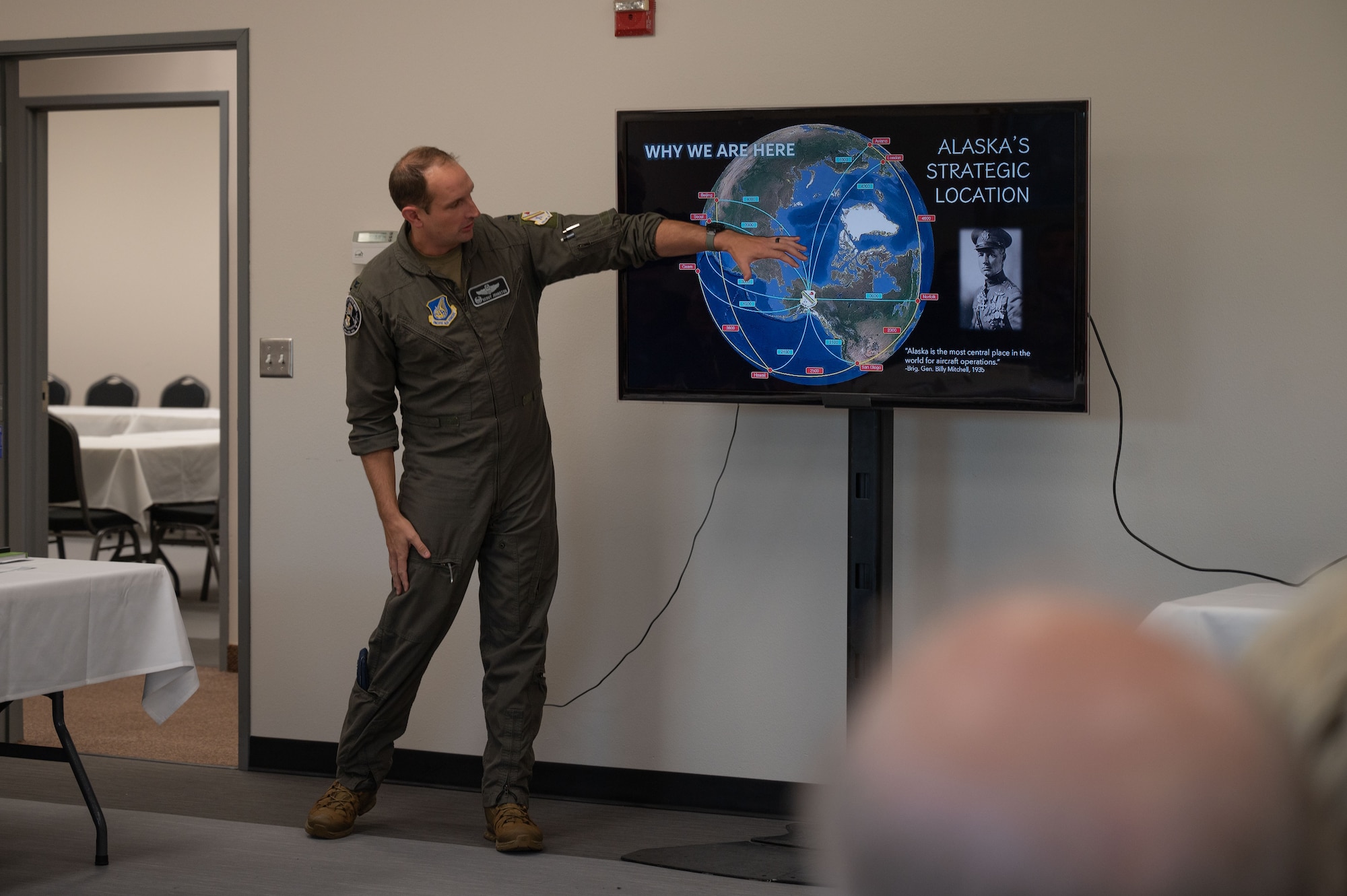 Colonel points at map on screen