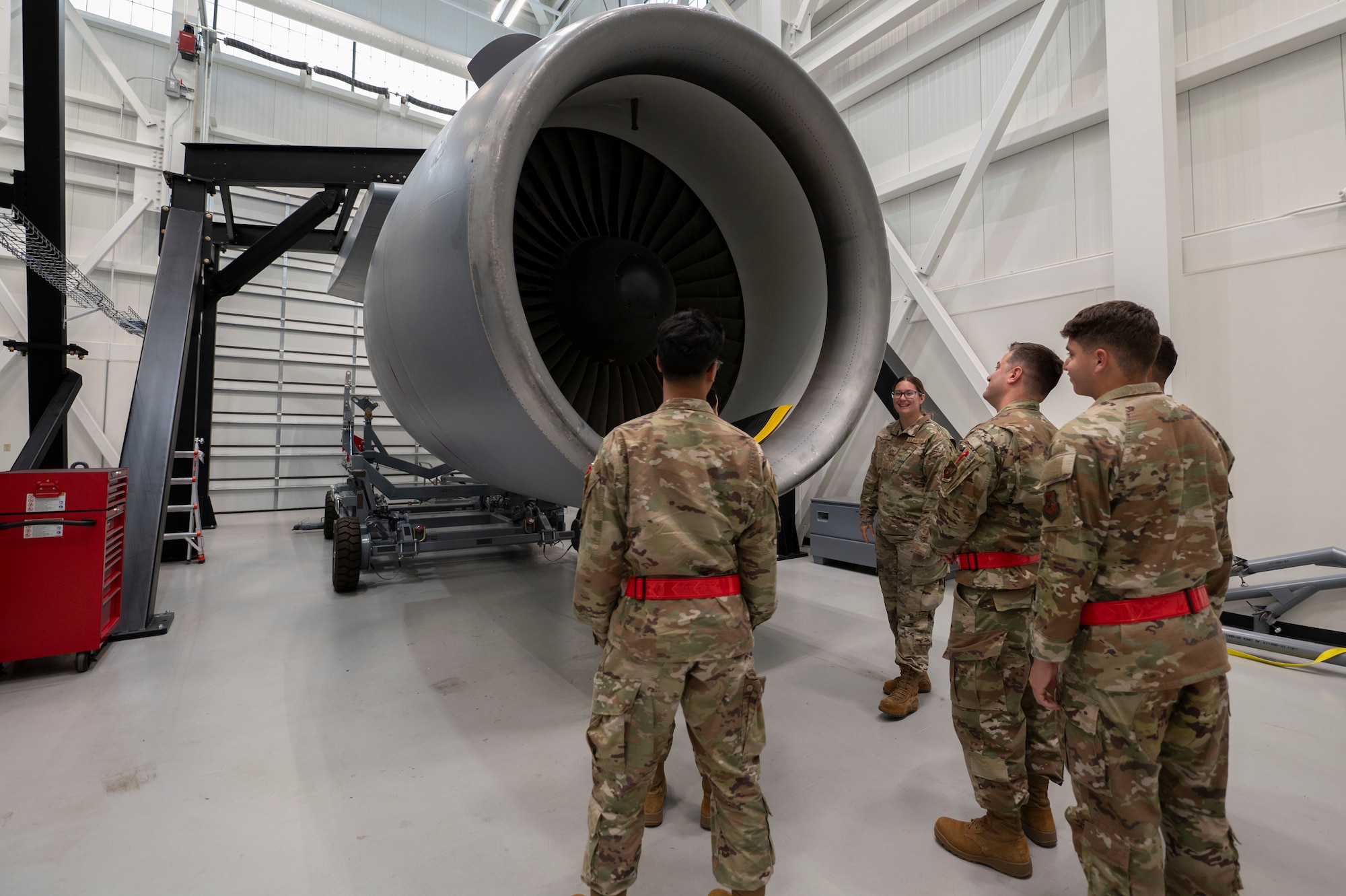 U.S. Air Force Tech. Sgt. Melissa Davis, 373rd Training Squadron Detachment 1 KC-46A Pegasus Mission Ready Airmen instructor, briefs students while giving them a tour of the training equipment at Joint Base McGuire-Dix-Lakehurst, N.J., Sept. 9, 2025. The training engine is one of many systems instructors inspected and approved for future classes.