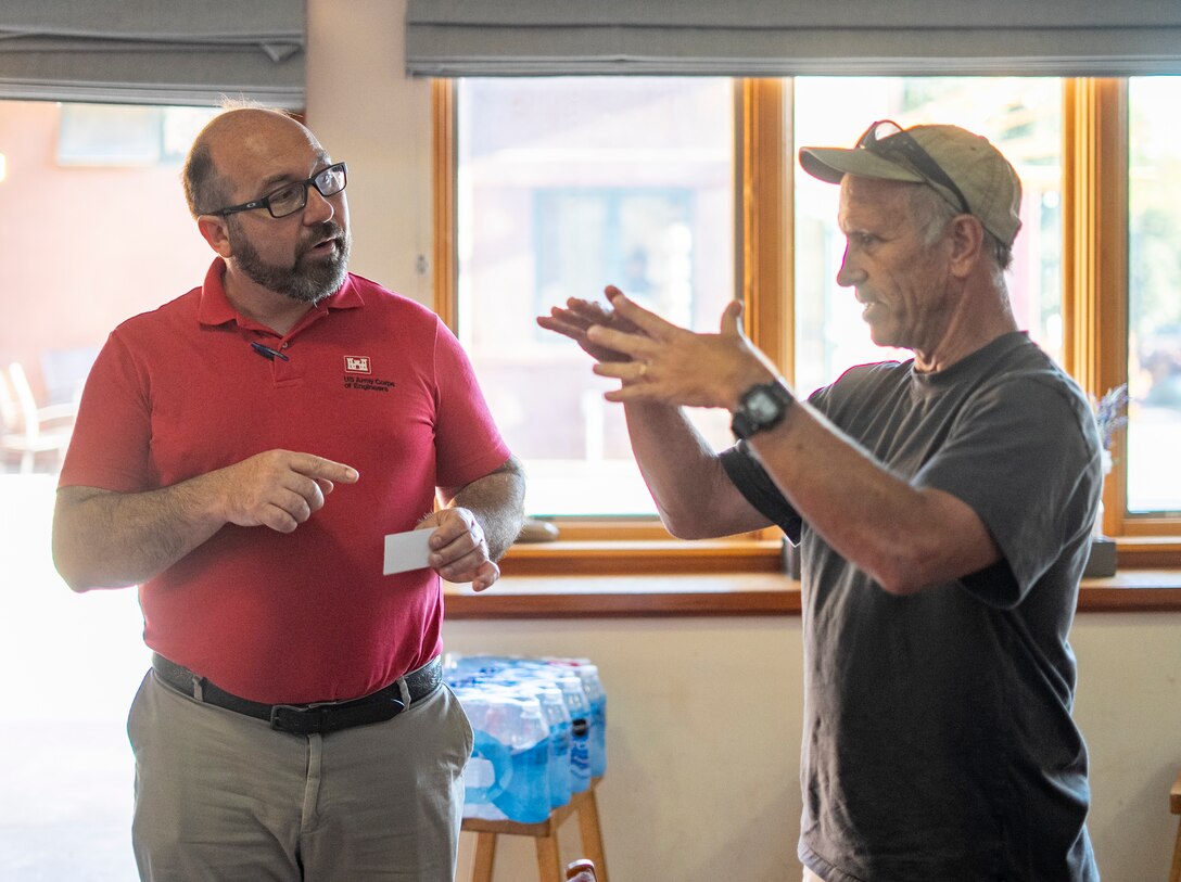 Daniel Huff, U.S. Army Corps of Engineers project manager, left, talks with a San Luis Obispo community member during a public meeting Aug. 25 at the San Luis Obispo Botanical Garden, California.