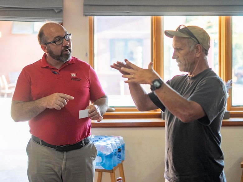 Daniel Huff, U.S. Army Corps of Engineers project manager, left, talks with a San Luis Obispo community member during a public meeting Aug. 25 at the San Luis Obispo Botanical Garden, California.