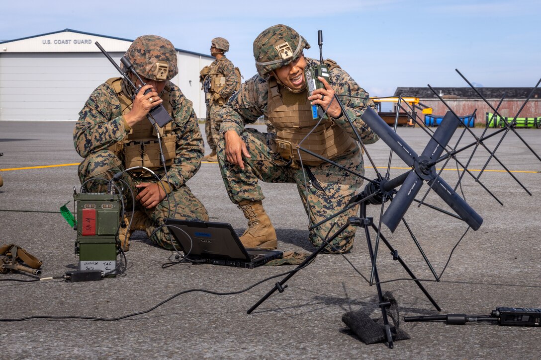 U.S. Marines with 7th Marine Regiment, 1st Marine Division, relays information during High Mobility Artillery Rocket System (HIMARS) Dry-Fire training as part of ARTIC EDGE 25 at Cold Bay, Alaska, Aug. 17th, 2025. AE25 is a NORAD and U.S. Northern Command-led homeland defense exercise designed to improve readiness, demonstrate capabilities and enhance Joint and Allied Force interoperability in the Arctic. (U.S. Marine Corps Photo by Lance Cpl. Edward Spears)