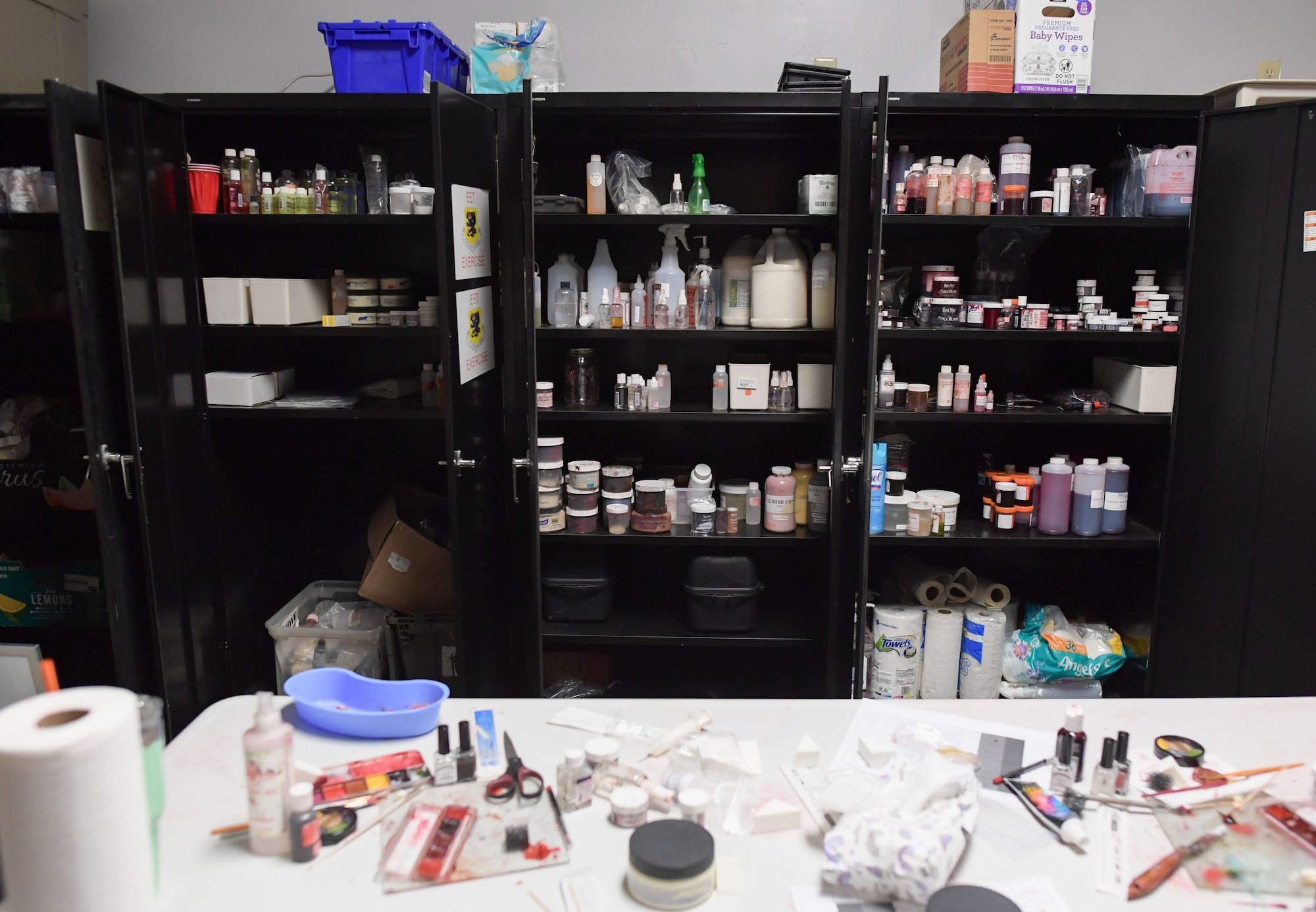 moulage supplies are displayed inside black metal cabinets