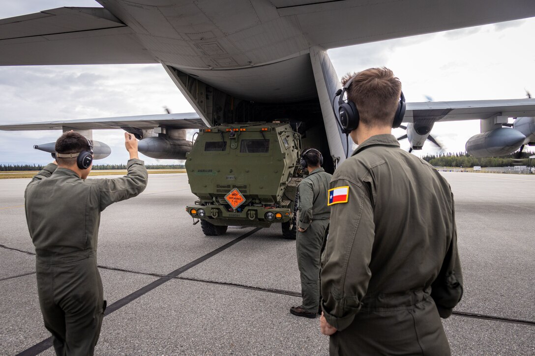 U.S. Marines with Marine Aerial Refueler Squadron 234 (VMGR-234), Marine Aircraft Group 41, 4th Marine Aircraft Wing, offload a High Mobility Artillery Rocket System (HIMARS) during ARCTIC EDGE 2025 (AE25) at Fort Greenly, Alaska, Aug. 22, 2025. Specialized Arctic training generates valuable lessons learned for warfighters and enablers ensuring they can execute their assigned missions in any environment. AE25 is a NORAD and U.S. Northern Command-led homeland defense exercise designed to improve readiness, demonstrate capabilities and enhance Joint and Allied Force interoperability in the Arctic. (U.S. Marine Corps Photo by Lance Cpl. Edward Spears.)