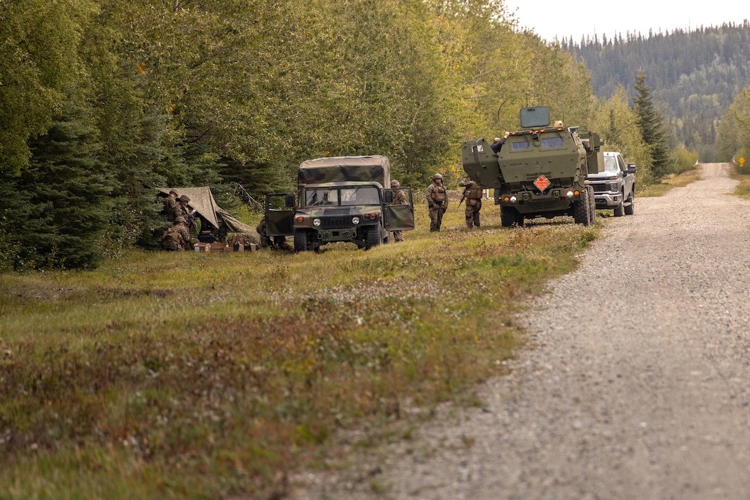 U.S. Marines Capt. Alex Hoppman, platoon commander, with 2nd Battalion, 14th Marine regiment, 4th Marine Division, reads documents during ARCTIC EDGE 2025 (AE25) at Donnely Training Area, Alaska, Aug. 22, 2025. Specialized Arctic training generates valuable lessons learned for warfighters and enablers ensuring they can execute their assigned missions in any environment. AE25 is a NORAD and U.S. Northern Command-led homeland defense exercise designed to improve readiness, demonstrate capabilities and enhance Joint and Allied Force interoperability in the Arctic. (U.S. Marine Corps Photo by Lance Cpl. Edward Spears.)