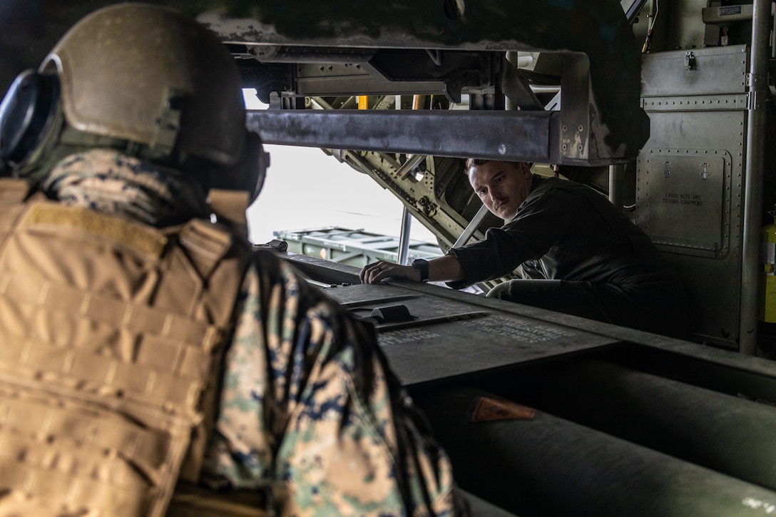 U.S. Marines Sgt. Julio Torres, left, High Mobility Artillery Rocket System (HIMARS) launcher chief, with 2nd Battalion, 14th Marine regiment, 4th Marine Division, and Staff Sgt. Tristan Riggs, flight engineer, with Marine Aerial Refueler Squadron 234 (VMGR-234), 4th Marine Aircraft Wing, load new rocket casing during ARCTIC EDGE 2025 (AE25) at Fort Greenly, Alaska, Aug. 22, 2025. Specialized Arctic training generates valuable lessons learned for warfighters and enablers ensuring they can execute their assigned missions in any environment. AE25 is a NORAD and U.S. Northern Command-led homeland defense exercise designed to improve readiness, demonstrate capabilities and enhance Joint and Allied Force interoperability in the Arctic. AE25 is a NORAD and U.S. Northern Command-led homeland defense exercise designed to improve readiness, demonstrate capabilities and enhance Joint and Allied Force interoperability in the Arctic.(U.S. Marine Corps Photo by Lance Cpl. Edward Spears.)