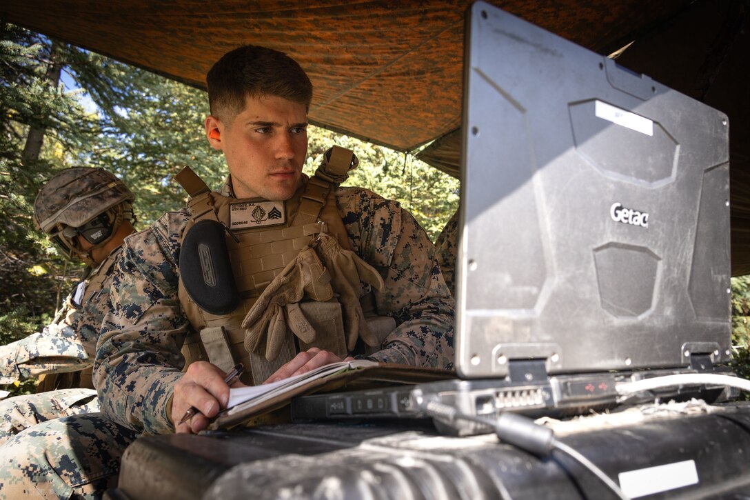 U.S. Marine Sgt. Dominic Detente, High Mobility Artillery Rocket System launcher operator, with 2nd Battalion, 14th Marine regiment, 4th Marine Division, directs coordinates during ARCTIC EDGE 2025 (AE25) at Donnely Training Area, Alaska, Aug. 22, 2025. Specialized Arctic training generates valuable lessons learned for warfighters and enablers ensuring they can execute their assigned missions in any environment. AE25 is a NORAD and U.S. Northern Command-led homeland defense exercise designed to improve readiness, demonstrate capabilities and enhance Joint and Allied Force interoperability in the Arctic. (U.S. Marine Corps Photo by Lance Cpl. Edward Spears.)