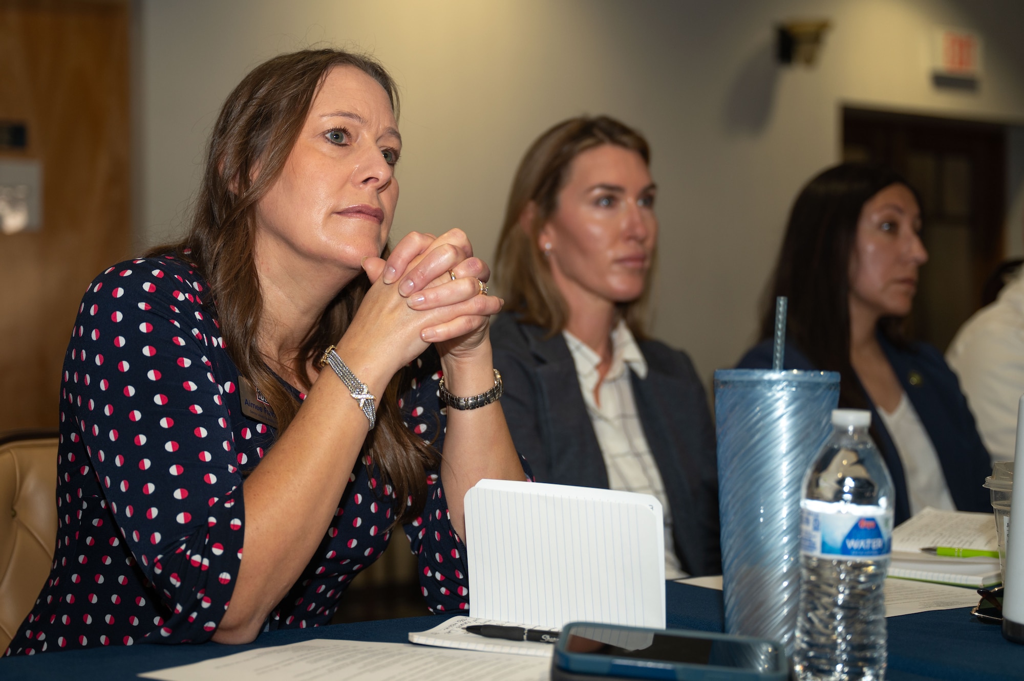 Aimee Randazzo, United Service Organization senior operations manager, listens to a presentation during the Arizona Commanders Summit at Davis-Monthan Air Force Base, Arizona, September 9, 2025. The summit is held every six months to bring together Arizona community and military leaders to discuss topics surrounding military installations.(U.S. Air Force photo by Airman Jaden Kidd)
