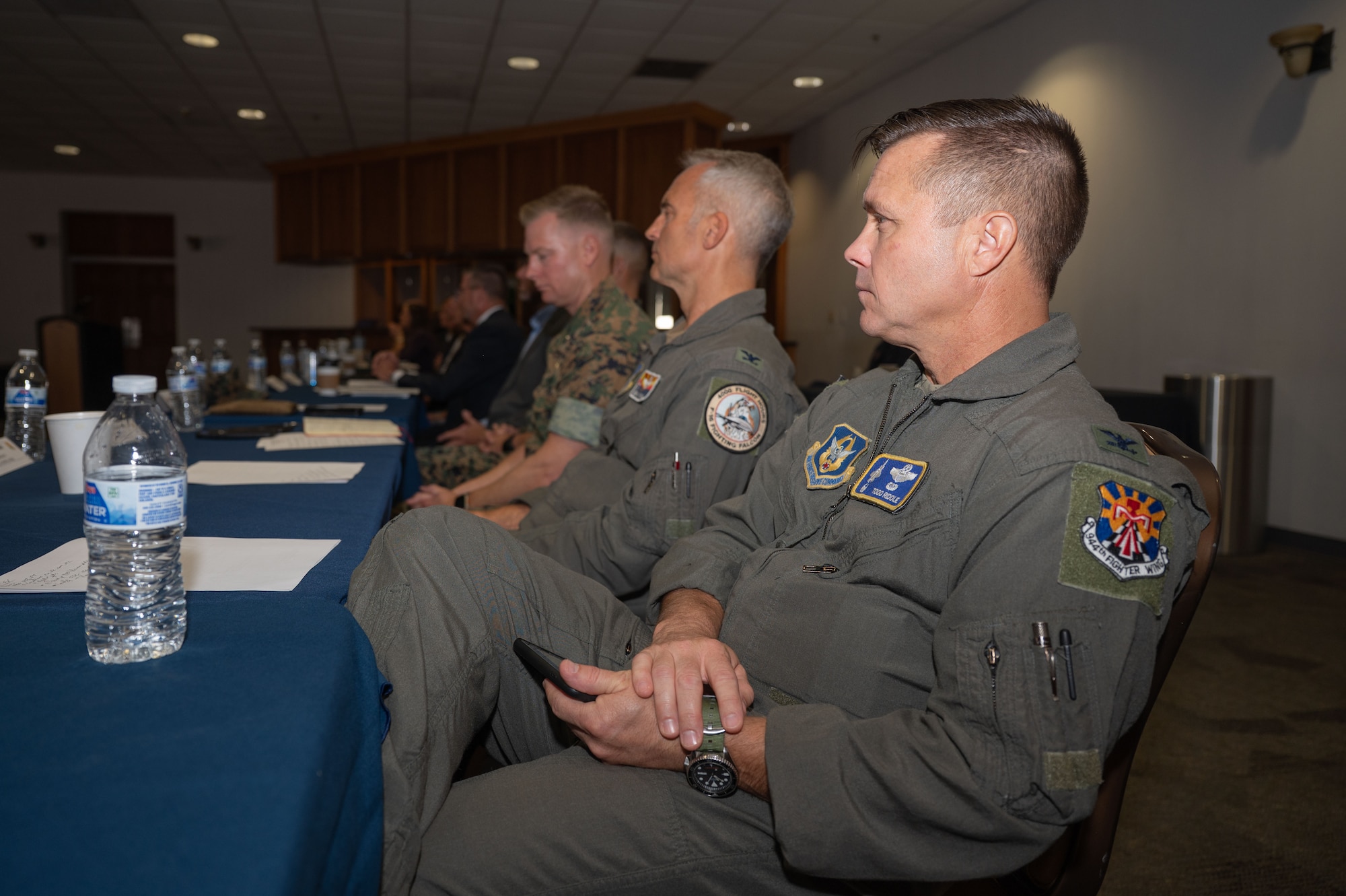 U.S. Air Force Col. Tom Riddle, 944th Fighter Wing commander, listens to a presentation during the Arizona Commanders Summit at Davis-Monthan Air Force Base, Arizona, September 9, 2025. Arizona military and community leaders gathered to give an overview of their respective installations as well as discuss topics surrounding military bases. (U.S. Air Force photo by Airman Jaden Kidd)