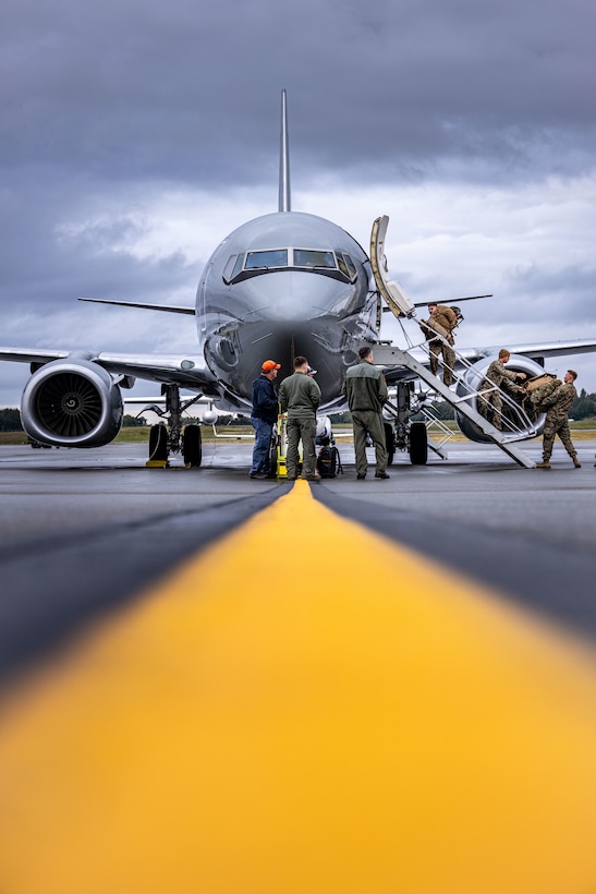 U.S. Marines with 3rd Low Altitude Air Defense Battalion, load a C-40A aircraft, assigned to Marine Transport Squadron (VMR) 1, Marine Air Group 41, 4th Marine Air Wing, during ARCTIC EDGE 2025 (AE25) at Joint Base Elmendorf-Richardson, Alaska, Aug. 21, 2025. Specialized Arctic training generates valuable lessons learned for warfighters and enablers ensuring they can execute their assigned missions in any environment. AE25 is a NORAD and U.S. Northern Command-led homeland defense exercise designed to improve readiness, demonstrate capabilities and enhance Joint and Allied Force interoperability in the Arctic. (U.S. Marine Corps Photo by Lance Cpl. Edward Spears)