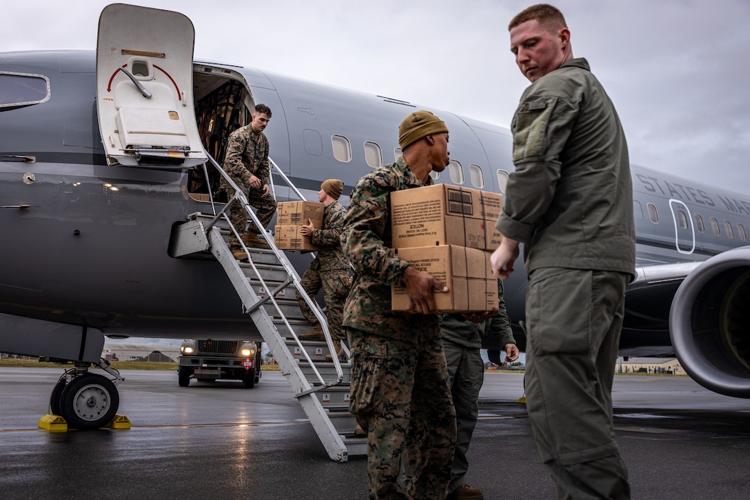 U.S. Marines with 3rd Low Altitude Air Defense Battalion, and Marine Transport Squadron (VMR) 1, Marine Air Group 41, 4th Marine Air Wing, load a C-40A aircraft during ARCTIC EDGE 2025 (AE25) at Joint Base Elmendorf-Richardson, Alaska, Aug. 21, 2025. Specialized Arctic training generates valuable lessons learned for warfighters and enablers ensuring they can execute their assigned missions in any environment. AE25 is a NORAD and U.S. Northern Command-led homeland defense exercise designed to improve readiness, demonstrate capabilities and enhance Joint and Allied Force interoperability in the Arctic. (U.S. Marine Corps Photo by Lance Cpl. Edward Spears)