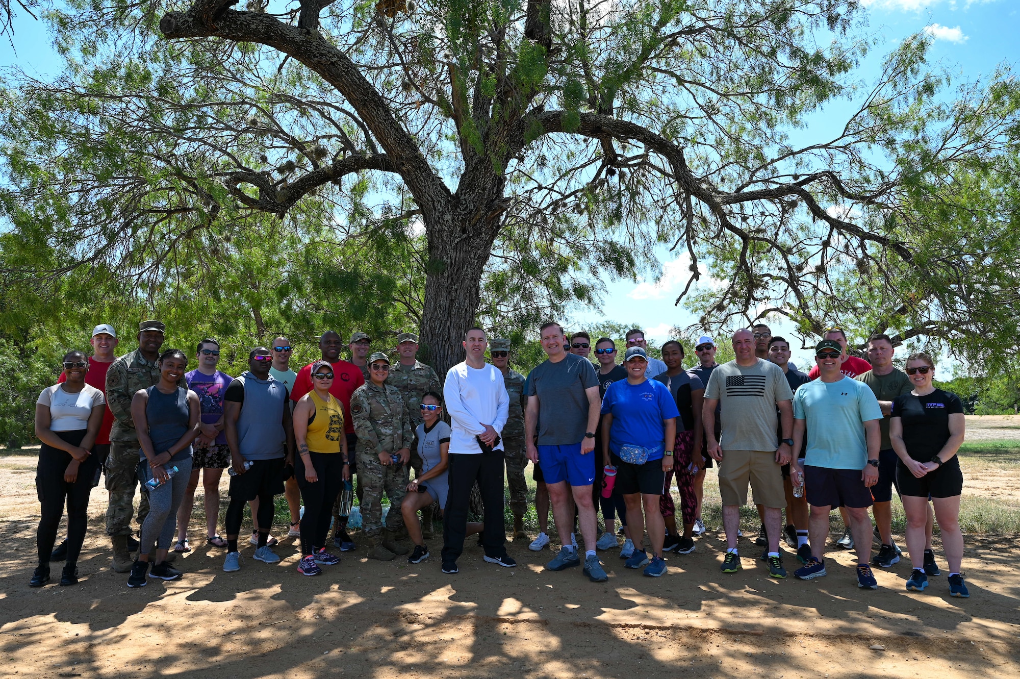 Members of the 960th Cyberspace Wing and 433rd Airlift Wing pose for a group photo Sept. 2, 2025, at Joint Base San Antonio-Lackland, Texas, after participating in a 5K run to kick off National Suicide Awareness and Prevention Month.