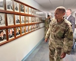 Brig. Gen. YR Summons Defense Health Network West, Director, and Medical Readiness Command West, Commanding General, looks back on almost 200 years of Army medical history on Fort Leavenworth during a tour of the facility Sept. 3. Photos of the post’s previous medical commanders displayed in the command hallway date back to 1827.