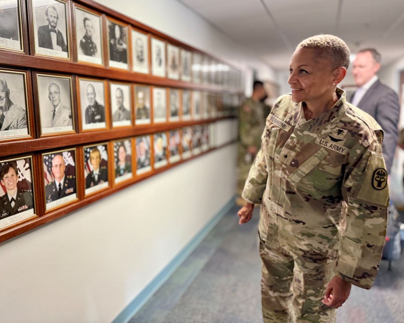 Brig. Gen. YR Summons Defense Health Network West, Director, and Medical Readiness Command West, Commanding General, looks back on almost 200 years of Army medical history on Fort Leavenworth during a tour of the facility Sept. 3. Photos of the post’s previous medical commanders displayed in the command hallway date back to 1827.