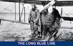 Distinguished Coast Guard pilot Charles Thrun standing on an OL-5 float in an early aviator suit. Notice the landing gear folded into the float behind him. (Smithsonian Institution)