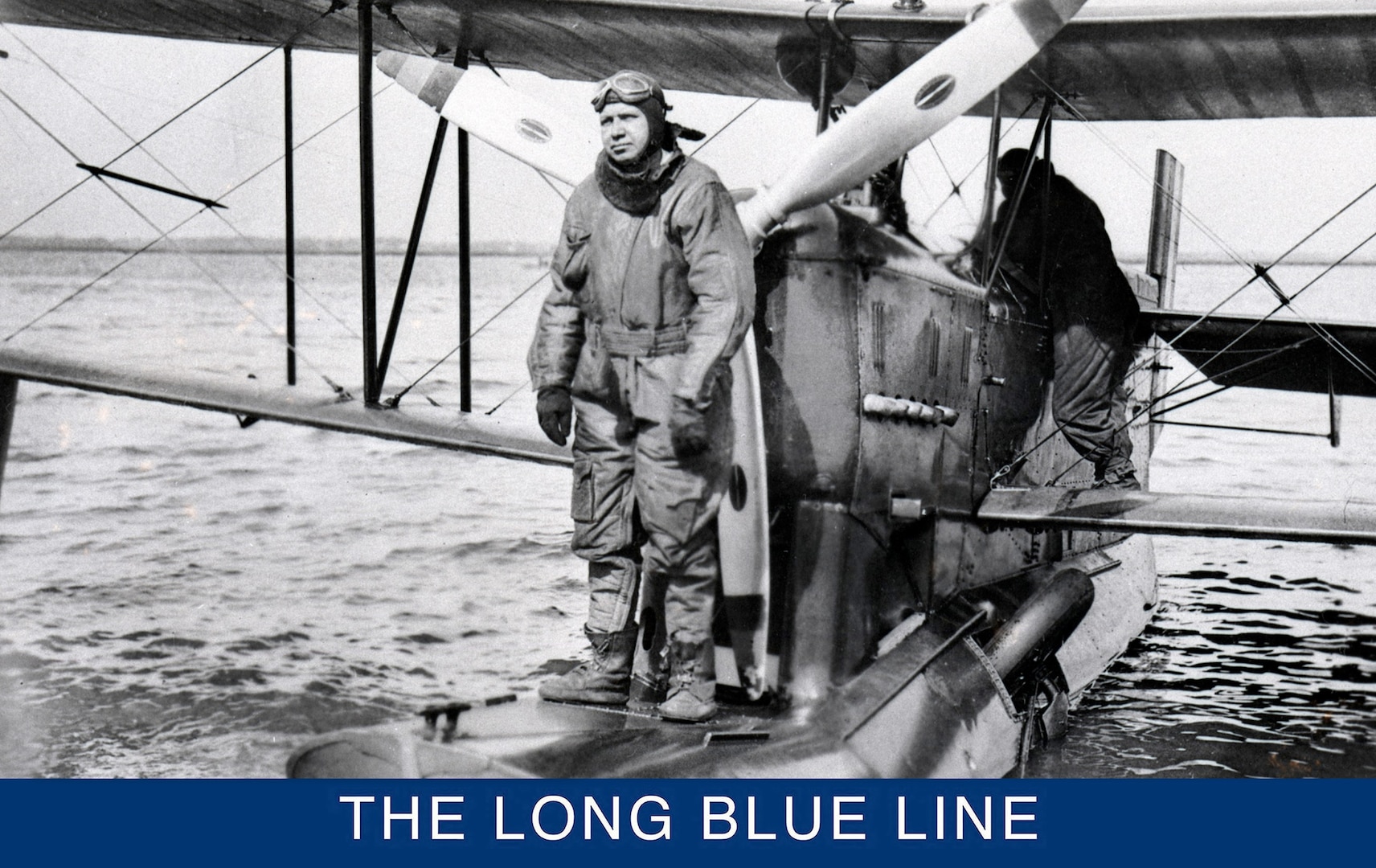 Distinguished Coast Guard pilot Charles Thrun standing on an OL-5 float in an early aviator suit. Notice the landing gear folded into the float behind him. (Smithsonian Institution)