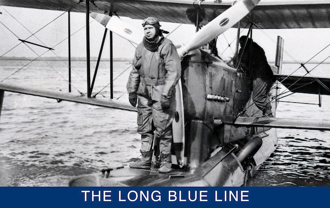 Distinguished Coast Guard pilot Charles Thrun standing on an OL-5 float in an early aviator suit. Notice the landing gear folded into the float behind him. (Smithsonian Institution)