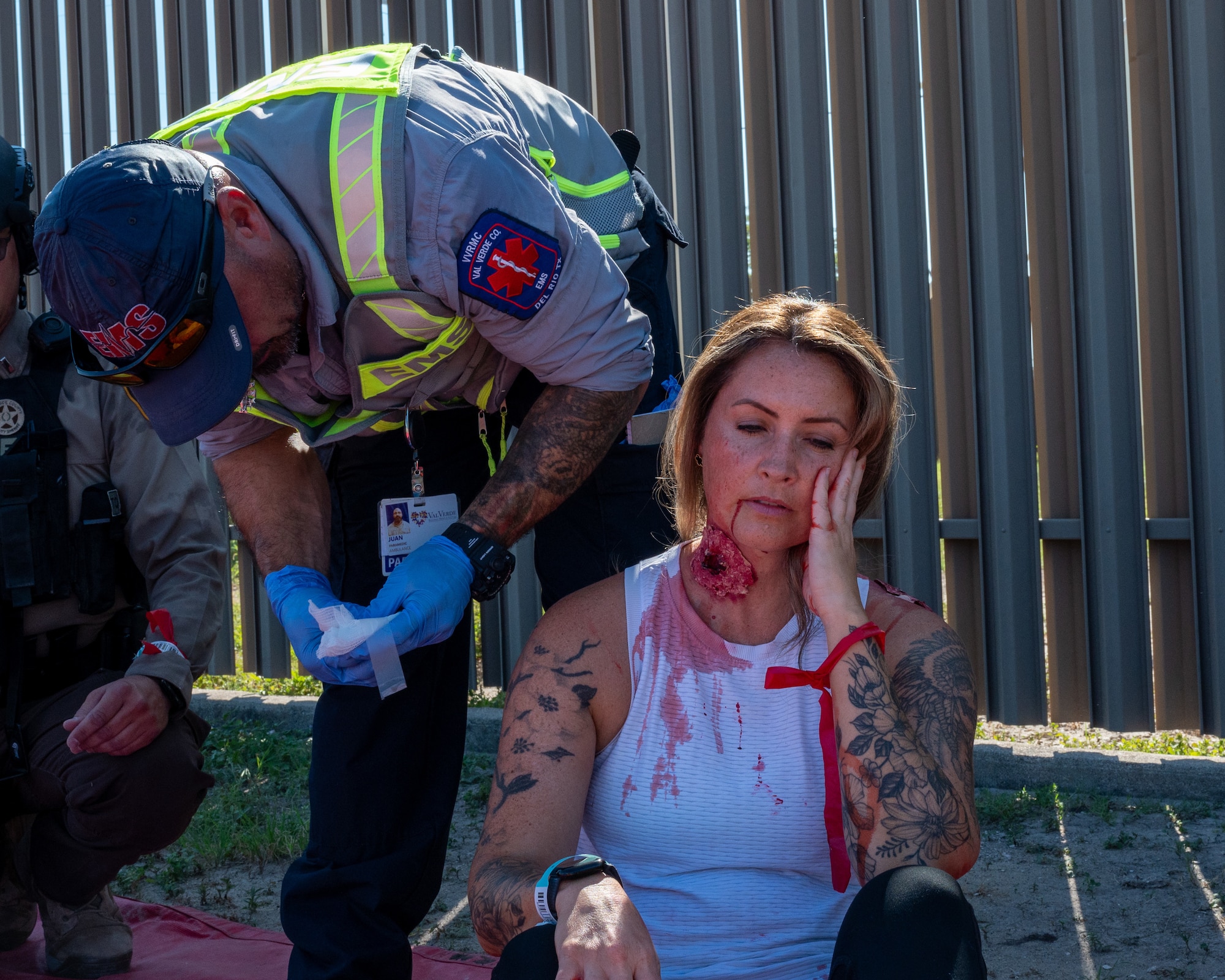 A Val Verde EMS performs aid on a wounded hostage to prepare for an air evacuation via helicopter during an exercise at Laughlin Air Force Base, Texas, Sept. 4, 2025. The Exercise was the first time air medical evacuation from the local area participated in a base exercise. (U.S. Air Force photo by Staff Sgt. Nicholas Larsen)